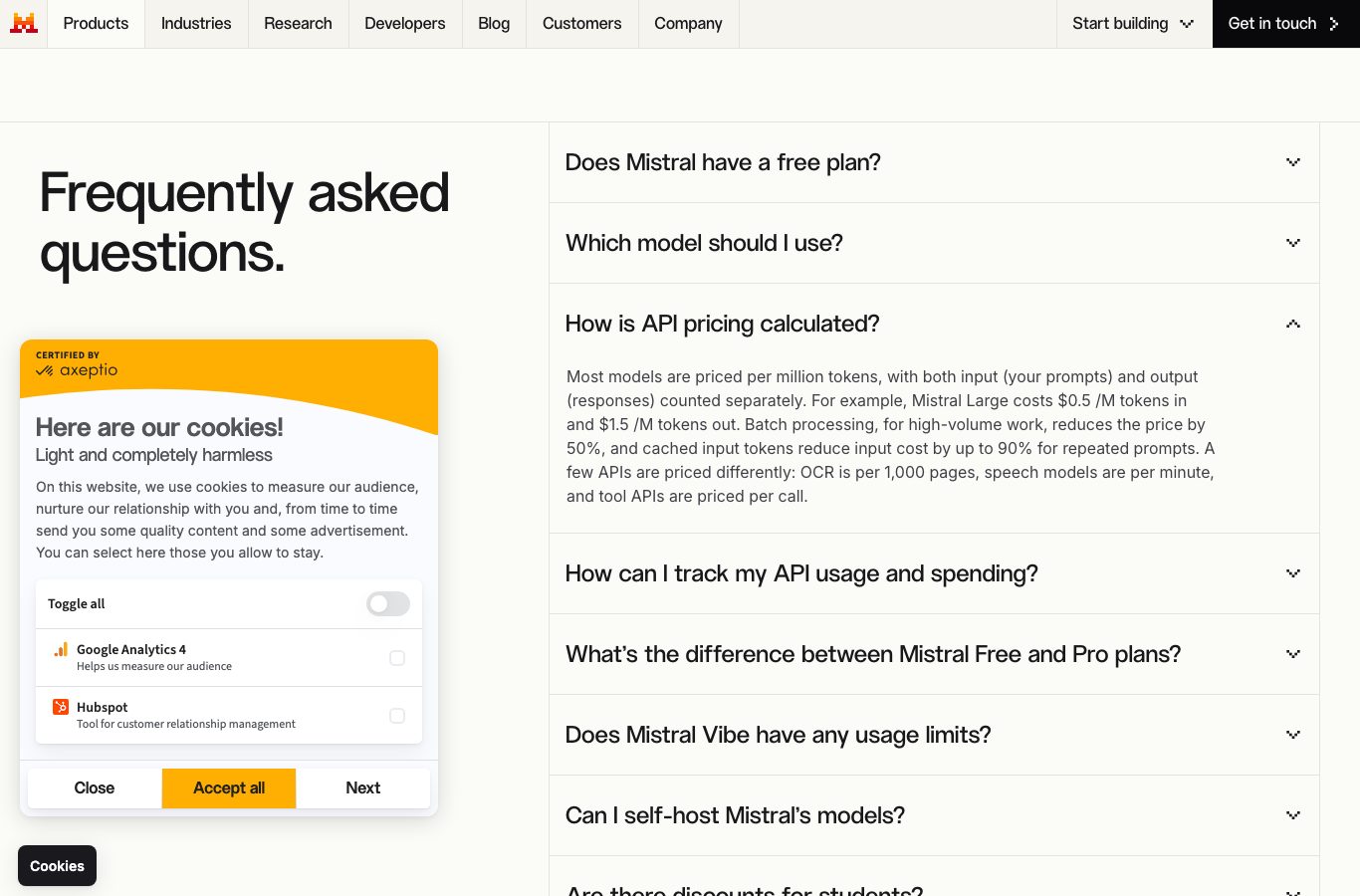Mistral AI pricing page: FAQ explaining that Mistral Large costs 0.5 dollars per million input tokens and 1.5 dollars per million output tokens